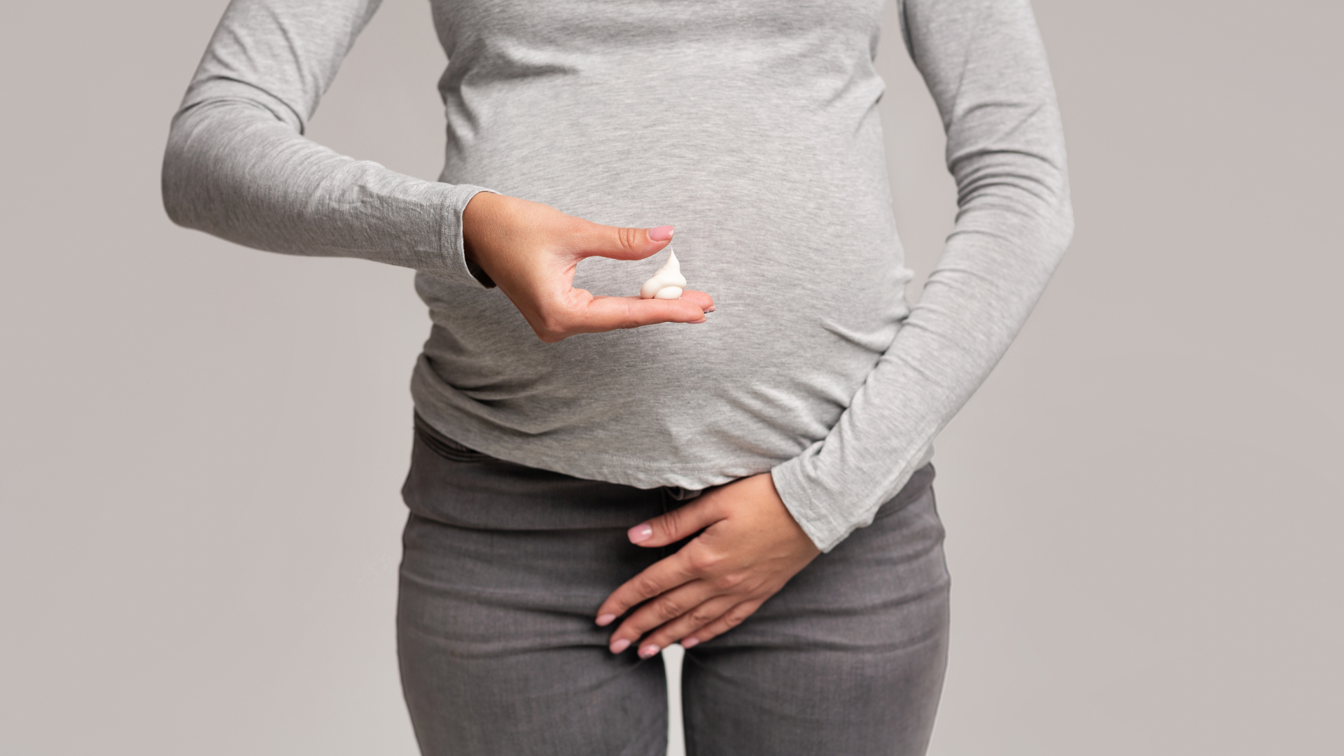 Woman holding Biolouve vaginal wellness supplement capsule representing natural intimate health support