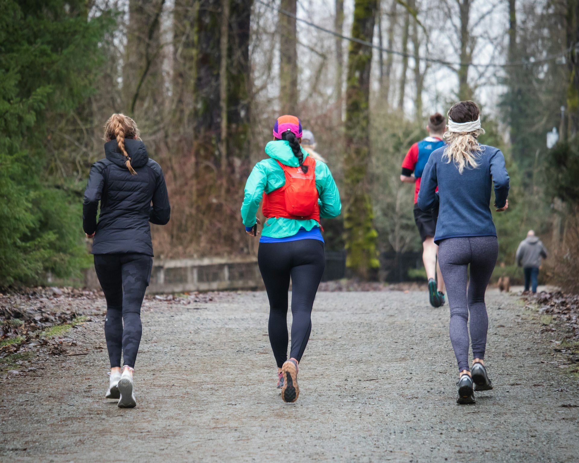 Group of women jogging together on forest trail representing active lifestyle and on-the-go freshness needs