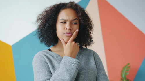 Woman thoughtfully evaluating wellness options