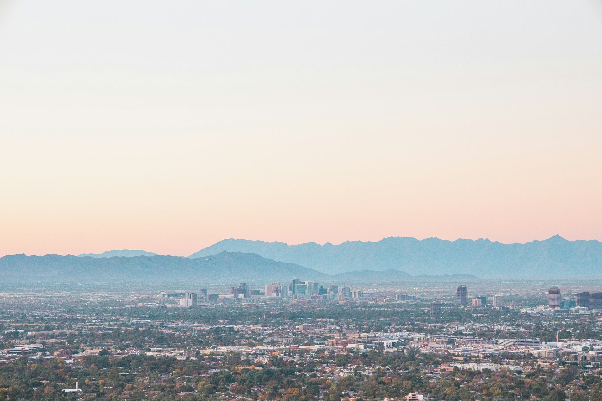 Phoenix Arizona skyline with desert mountains at sunset
