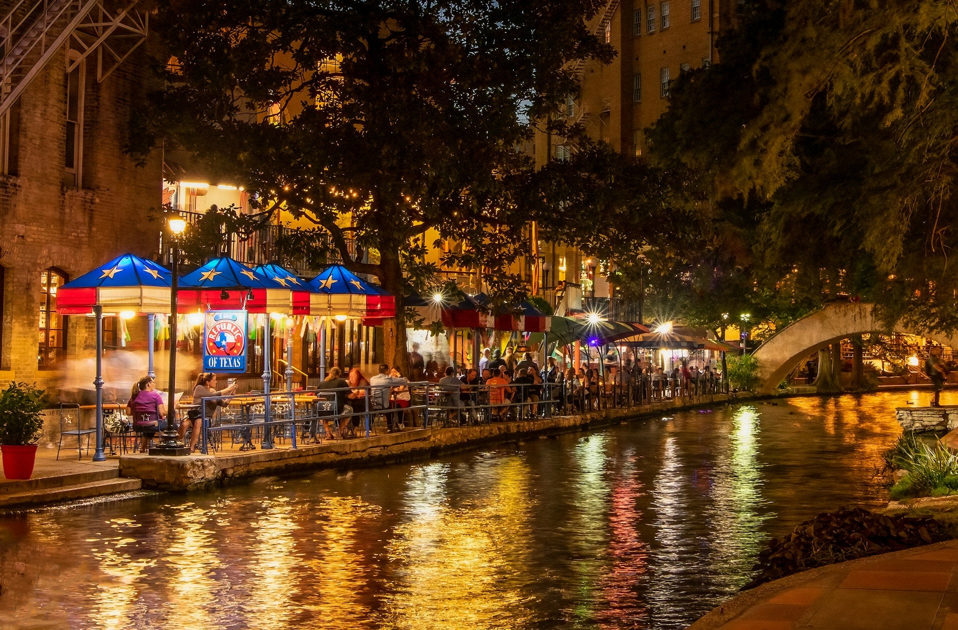 San Antonio River Walk at night with lights and restaurants