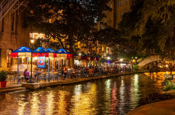 San Antonio River Walk at night with lights and restaurants