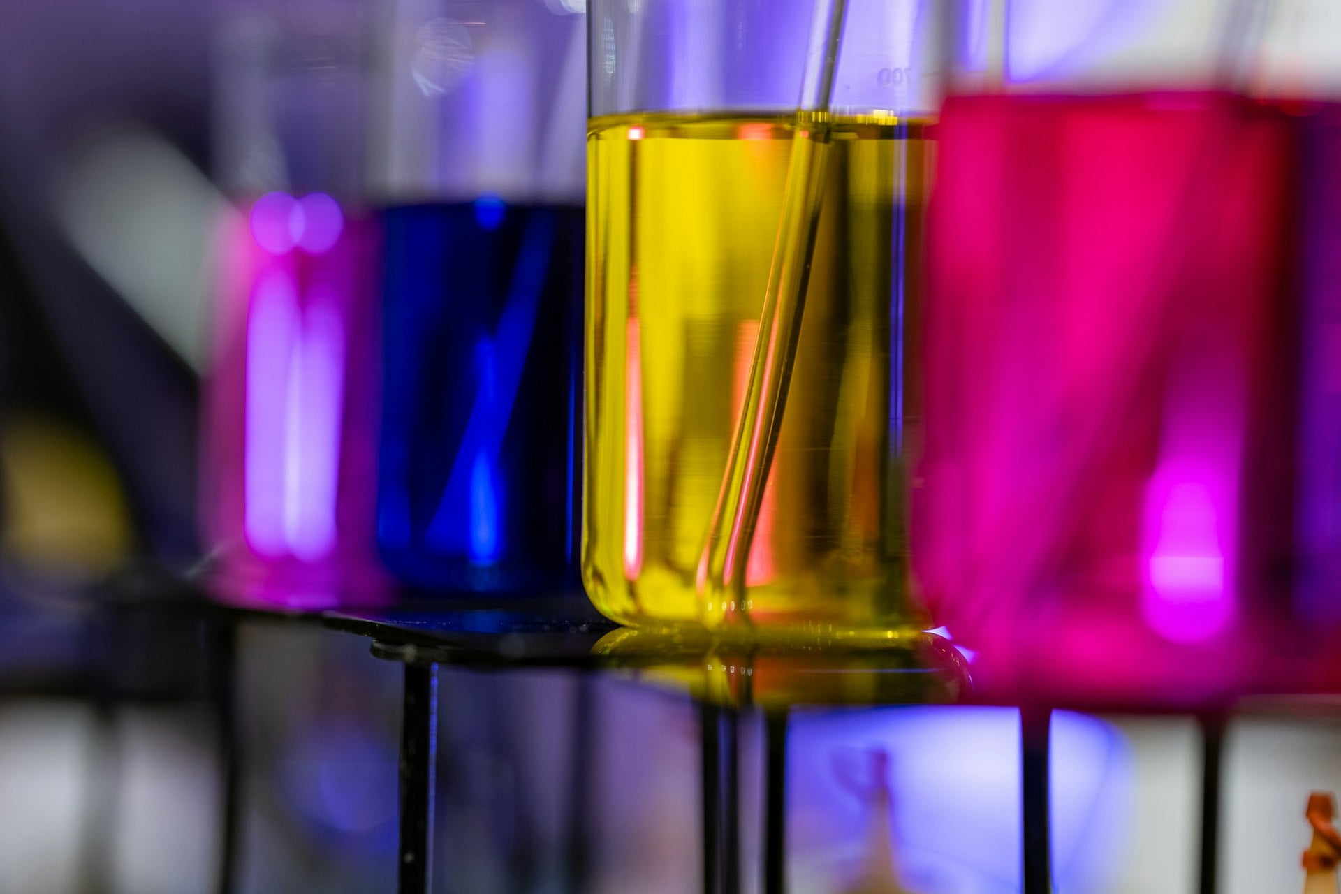 Colorful laboratory test tubes with pH solutions representing the science of intimate pH balance